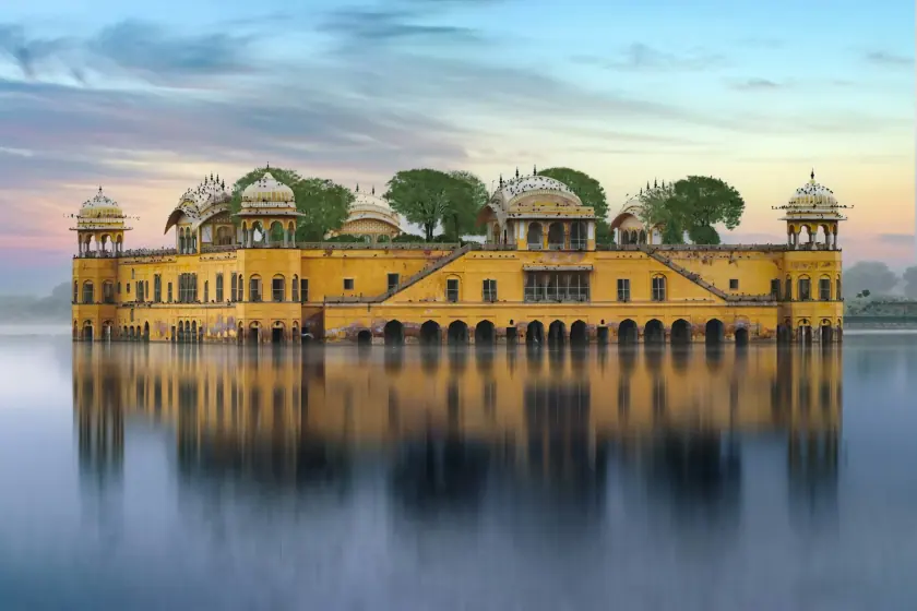 Palace reflected in a lake at sunset